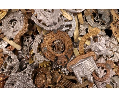 A quantity of British army cap badges etc