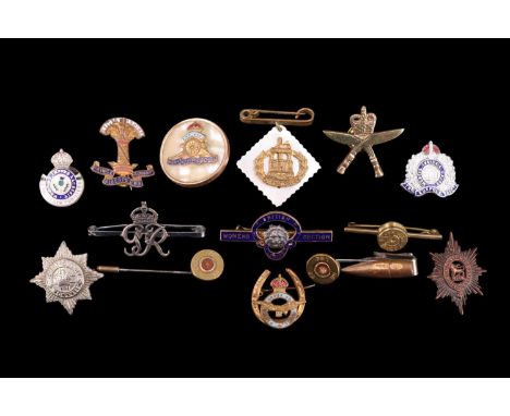 A small collection of military sweetheart brooches etc including a tie-clip and two stick pins incorporating cartridge heads