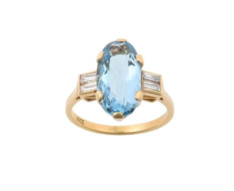 An Aquamarine and Diamond Ring the oval cut aquamarine in a yellow claw setting, flanked by pairs of baguette cut diamonds in