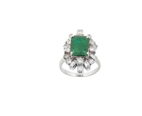 An Emerald and Diamond Cluster Ringthe emerald-cut emerald within a border of round brilliant cut, baguette cut and tapered b
