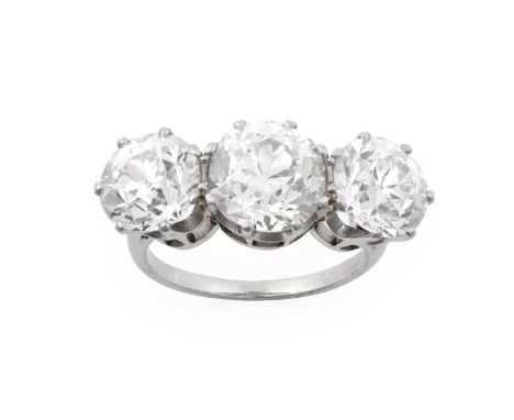 A Diamond Three Stone Ringthe graduated old cut diamonds in white claw settings, to a tapered shoulder plain polished shank, 