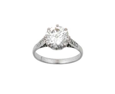 A Diamond Solitaire Ringthe round brilliant cut diamond in a white claw setting, to an eight-cut diamond set shoulder plain p