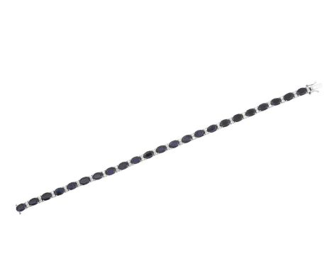 A Sapphire and Diamond Bracelet the twenty-three oval cut sapphires spaced by pairs of round brilliant cut diamonds, in white