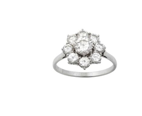 A Diamond Cluster Ringthe central raised round brilliant cut diamond within a border of round brilliant cut diamonds, in whit