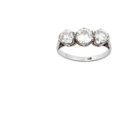 A Diamond Three Stone Ringa transitional cut diamond flanked by old cut diamonds, in white claw settings, to a tapered should