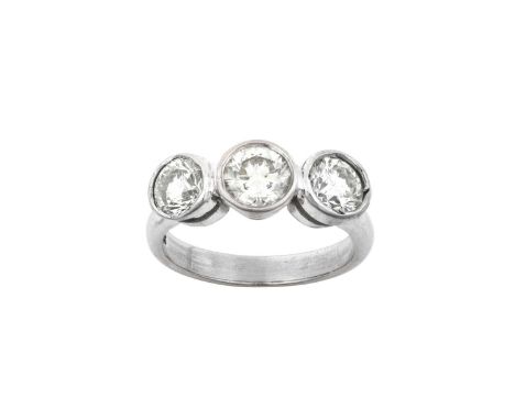 An 18 Carat White Gold Diamond Three Stone Ringthe old cut diamonds in rubbed over settings, to a plain polished shank, total