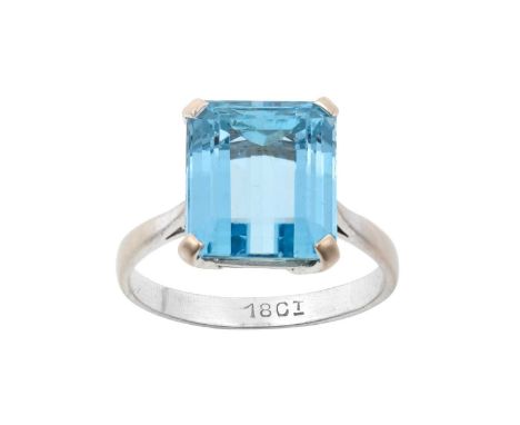 An Aquamarine Ringthe emerald-cut aquamarine in a white claw setting, to a tapered shoulder plain polished shankfinger size Q