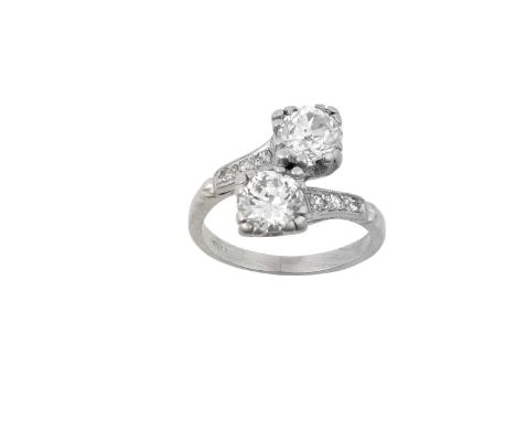 A Diamond Two Stone Twist Ringthe old cut diamond diagonally set to a round brilliant cut diamond, in white claw settings, to