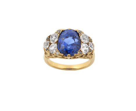 A Sapphire and Diamond Ring the old pear cut sapphire flanked by trios of old cut diamonds, with old cut and rose cut diamond