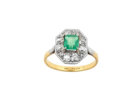 An Emerald and Diamond Cluster Ringthe rectangular step cut emerald in a white claw setting, within a border of old cut diamo