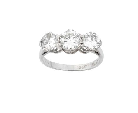 A Diamond Three Stone Ringthe round brilliant cut diamonds in white claw settings, to a tapered shoulder plain polished shank