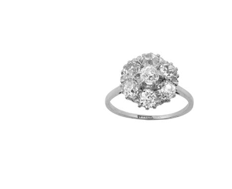 A Diamond Cluster Ringthe central raised old cut diamond within a border of old cut diamonds, in white claw settings, to a ta