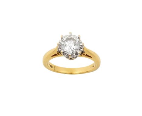 An 18 Carat Gold Diamond Solitaire Ringthe round brilliant cut diamond in a white claw setting, to a yellow tapered shoulder 
