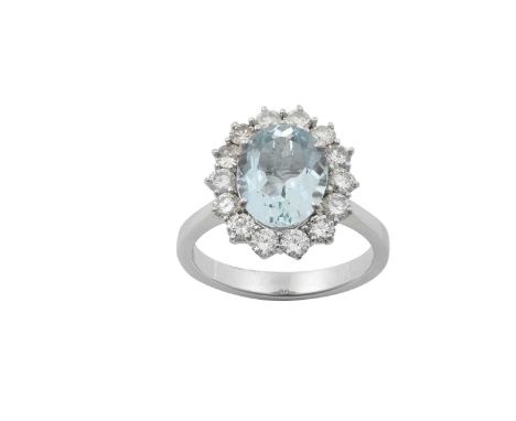 An 18 Carat White Gold Aquamarine and Diamond Cluster Ringthe oval cut aquamarine within a border of round brilliant cut diam