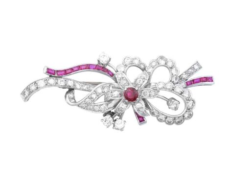 A Ruby and Diamond Broochmodelled as a stylised ribbon tied floral spray, set throughout with round brilliant cut and eight-c