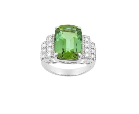 A Tourmaline and Diamond Ringthe cushion cut yellowish green tourmaline in a white four claw setting, to stepped round brilli