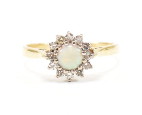 A vintage hallmarked 18ct yellow gold, opal and diamond halo ring. The retro ring having a round cut opal cabochon encompasse