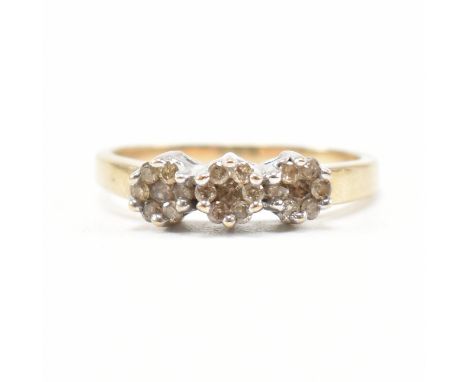 A hallmarked 9ct yellow gold and diamond cluster ring. The ring having three clusters of round cut diamonds to a tapered shan