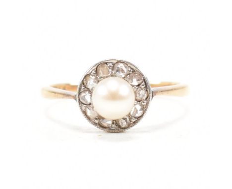 An Edwardian 18ct gold, pearl and diamond halo ring. The ring having a central round white pearl encompassed by a cluster of 