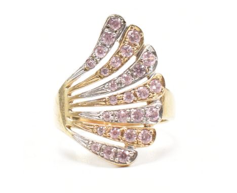 A hallmarked 9ct gold and pink stone cluster cocktail ring. The dress ring having a concave pierced fan of white and yellow g