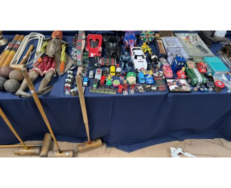 A croquet set together with toy cars, model figures, coins, puppet etc 