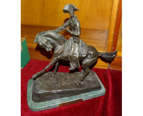 After Frederic Remington (American 1861-1909), 'Cowboy', a later cast bronze sculpture, signed on base, 31cm high, on marble 