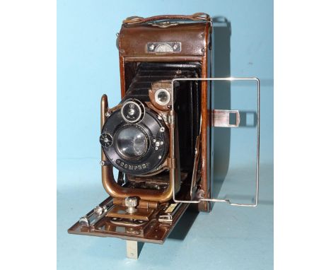 The Houghton-Butcher MFG Co. Ltd No.12 Ensign Carbine Tropical folding camera, with mahogany and oxidised metal case and leat