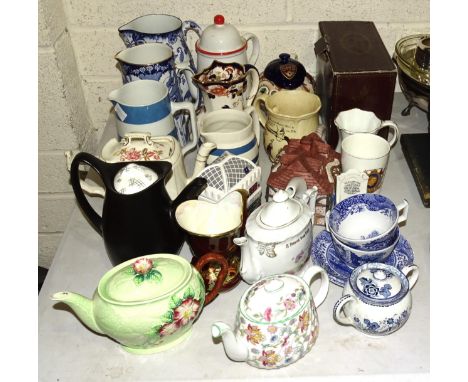 A Carltonware leaf and floral-decorated teapot, three cottage teapots, novelty and other teapots, jugs and other ceramics. 