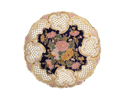 ZSOLNAY PECS: A LARGE PIERCED CHARGER, circular form with waved border, painted in polychrome with chrysanthemuns with gilt h