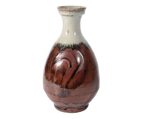 •JIM MALONE (b.1946) AN AINSTABLE STUDIO POTTERY VASE, fluted bottle form, incised with a comb decoration, covered in a tenmo