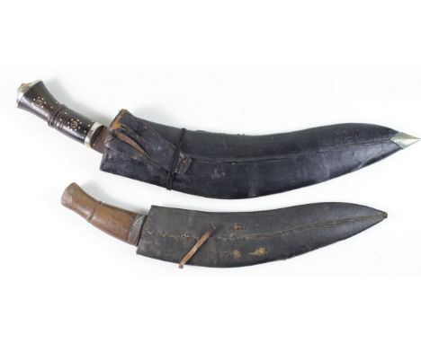 Indian Kukris: 1) a military type circa WW1 blade 13". Plain wood grip, unmarked in leather scabbard. Worn condition. 2) Larg