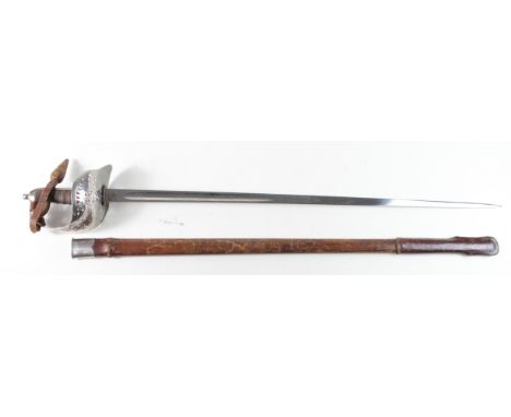 Sword: An Edward VII 1897 Pattern Infantry Officers Sword in its steel mounted leather, field service scabbard. Good blade 32