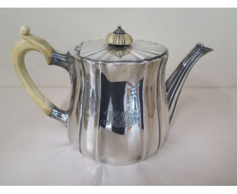 An Edwardian silver fluted teapot, London 1907/08 Sebastian Garrard, 22cm long, approx 25.9 troy oz, with engraving, some usa