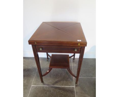 An Edwardian mahogany envelope fold over card table with a frieze drawer, 73cm tall x 54cm x 54cm closed, some wear to baize 