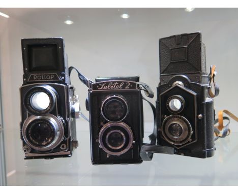 Three vintage TLR cameras; a Zeiss Ikon Ikoflex, a cased Lubitelz and a Rollop automatic, all have firing shutters and appear
