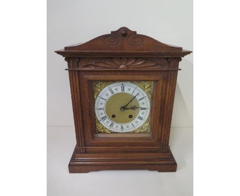 An oak striking mantle clock with a Lenzkirch movement with pendulum and key, in working order, 38cm tall x 29cm, missing thr