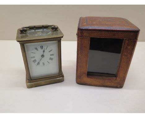 A brass carriage clock, 12cm tall, in running order, dial and glass good with original carry case and key 