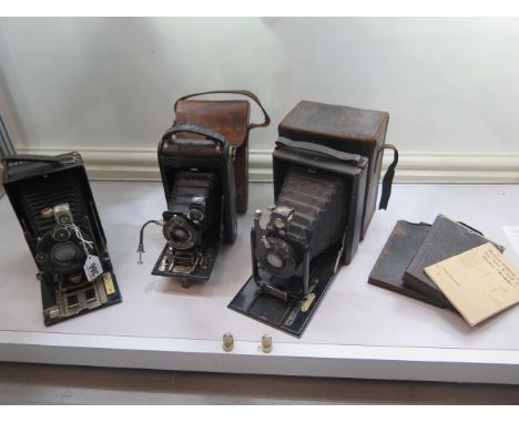 Three folding cameras; a Goerz Tenax plate camera, Kodak No:1 autographic JR in a leather case and a half plate (?) Voigtland