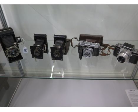 Five vintage film cameras to include an early EXA SLR, Art Deco design folding Kodak, Kodak Retina 1a and 2 Kodak vest pocket
