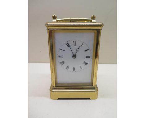 A brass French carriage clock strikes hours and half hours, 8 day movement, 15cm tall, in running order with key good conditi