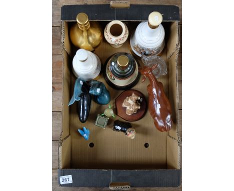 A collection of items to include Wade whiskey decanters, Poole pottery animals, unmarked animal figures etc (14)