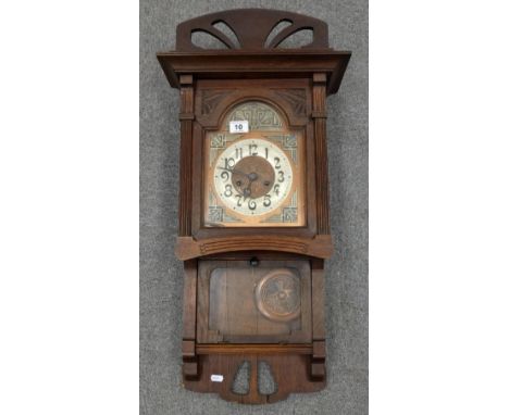Oak Cased wall clock with oriental influenced face