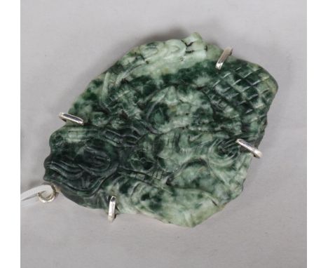 A Mayan jadeite carving of a mask in a white metal mount