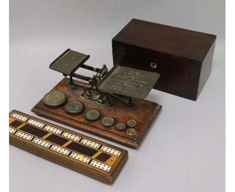 A set of Victorian postal scales and weights, a cribbage board and a tea caddy