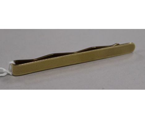 An engine-turned yellow metal tie clip (tests as 14ct), 11.1g