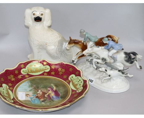 A Sitzendorf hunting group, a Vienna style dish and a Staffordshire spaniel group height 20cm width 25cm