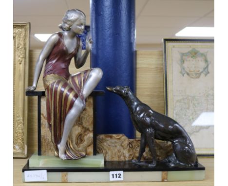 An Art Deco onyx and bronze spelter figure and dog group height 40cm