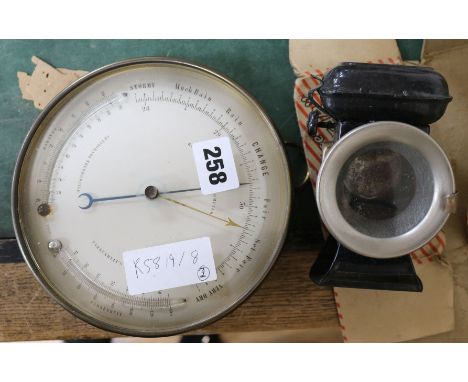 A brass aneroid barometer and twin thermometer and a three stars cycle lamp