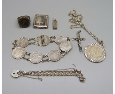 A silver pendant and chain, a small silver ingot pendant, a silver bracelet, a silver ring, a coin bracelet a/f, a small silv