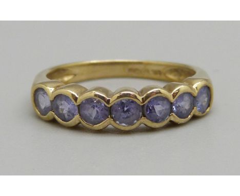 A 9ct gold, cornflower blue tanzanite seven stone ring, two stones a/f, 1.8g, K 